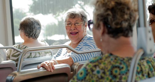 Seniors having a conversation riding Metro light rail train.