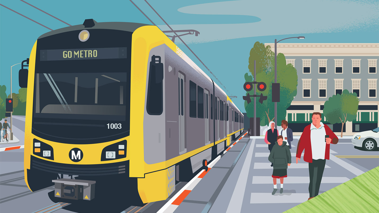 Pedestrians crossing the street with light rail vehicle passing through intersection.