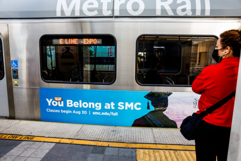 Metro Rail Expo Line car with passenger waiting to board featuring a King Ad.