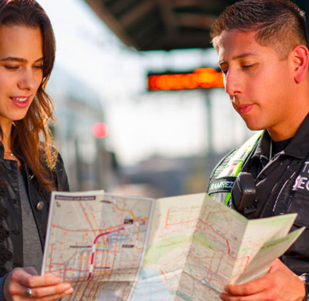 Passenger looking at map with Metro Transit Security Officer.