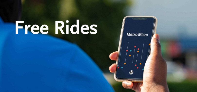 Person holding mobile phone using Metro Micro app.